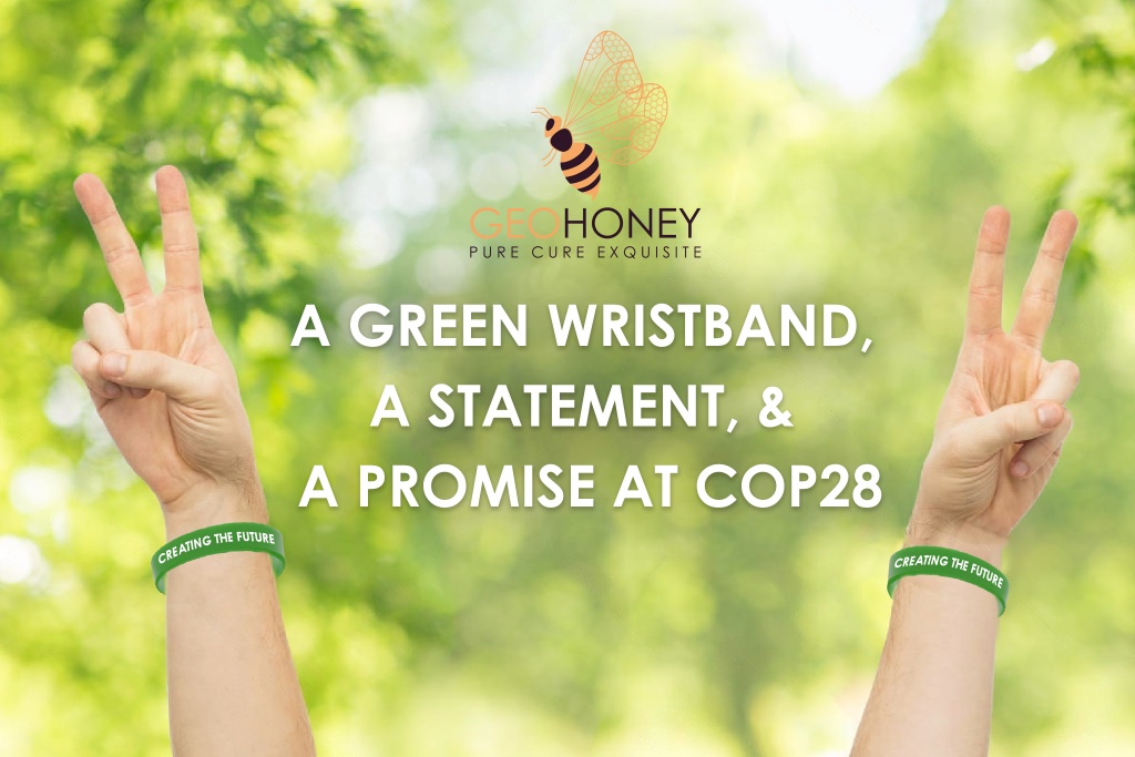 Two UAE leaders wearing green wristbands, the official COP28 conference wristband made of sustainable and recyclable materials.